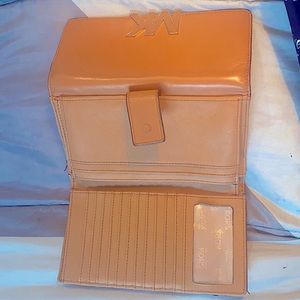 This is a tan 8 inch Michael Kors hand held wallet